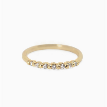 7 sparkling diamonds are set in this solid gold ring in a shared prong style setting