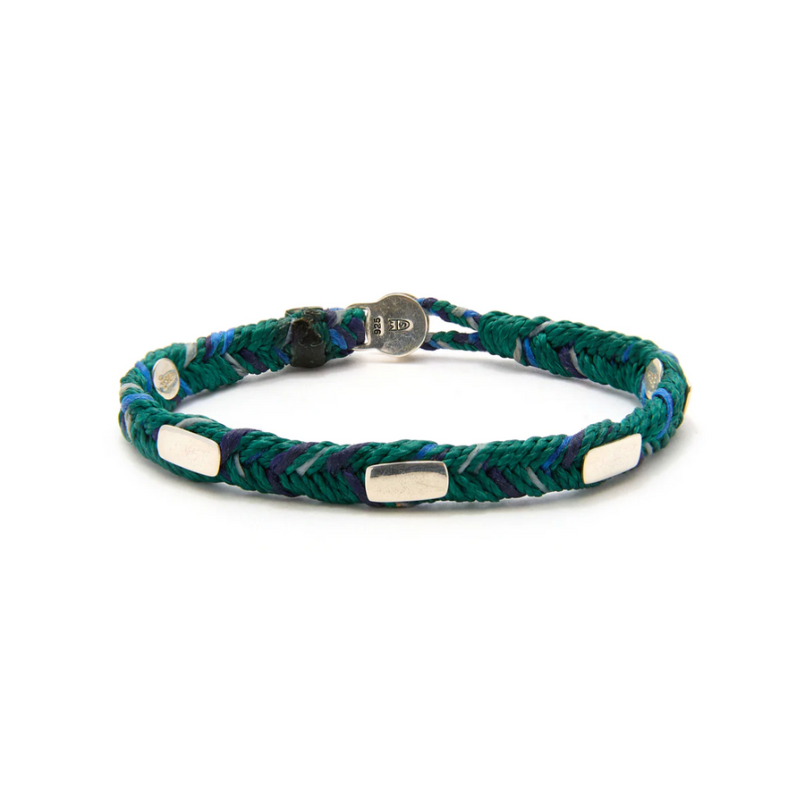Green braided bracelet with silver accents on a white background