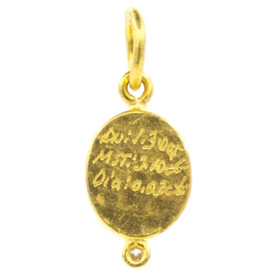 Gold pendant with engraved text on a white background