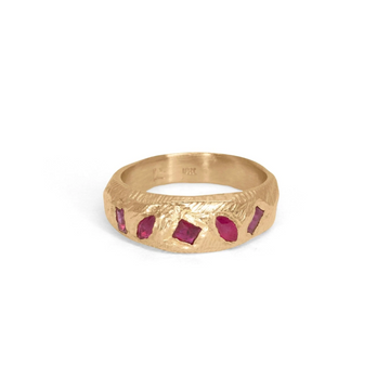 hand carved 18k gold band is set with five geometric rubies