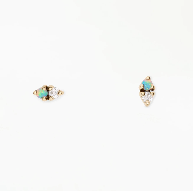 Pair of gold earrings with gemstones on a white background