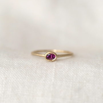 oval grape garnet bezel set in 14k gold on thin gold band