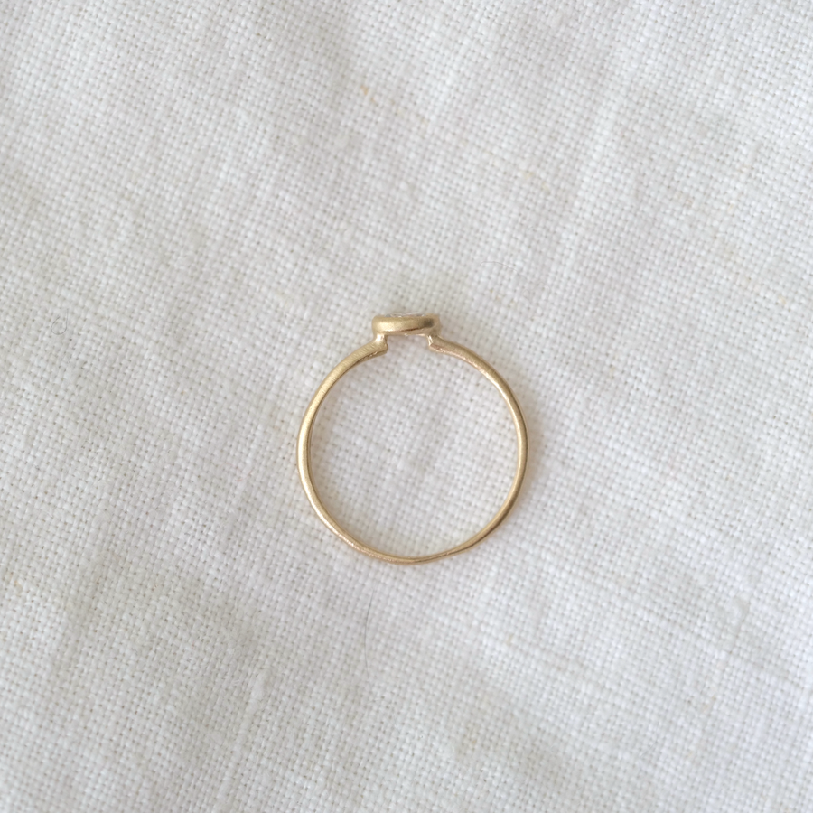 Gold ring on a light fabric background