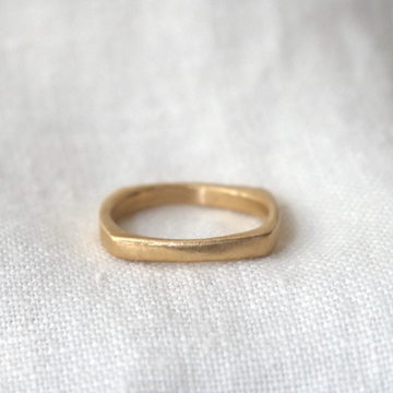 Gold ring on a white fabric background