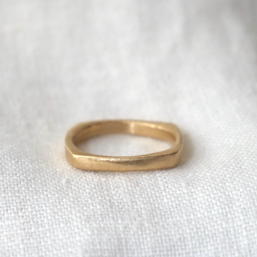 Gold ring on a white fabric background