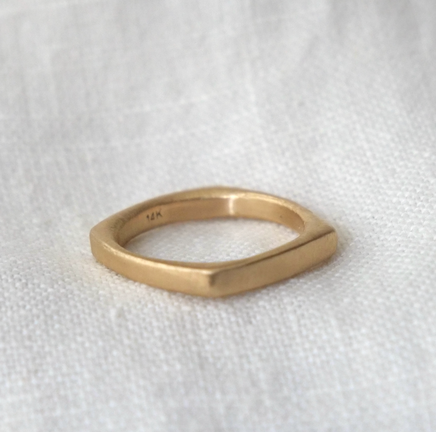 Gold ring on a white fabric background