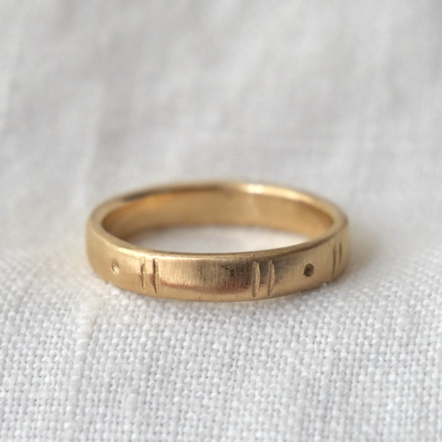 Gold ring on a white fabric background
