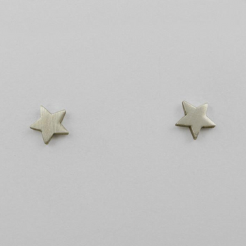 Star-shaped silver stud earrings on a light gray background