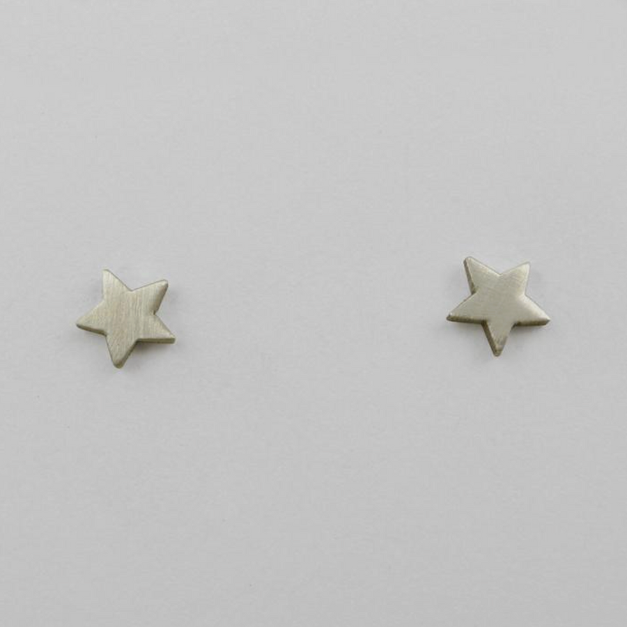 Star-shaped silver stud earrings on a light gray background
