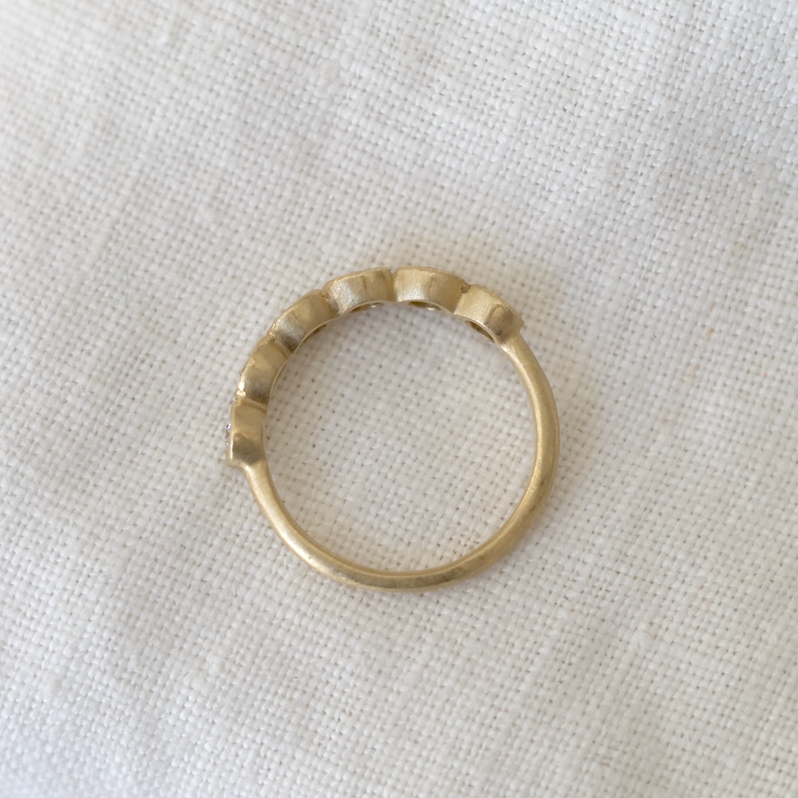 Gold ring on a light fabric background