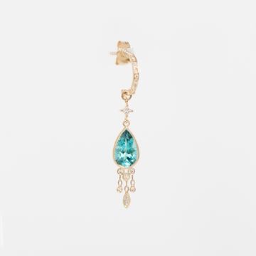 Gold earring with a blue gemstone on a white background