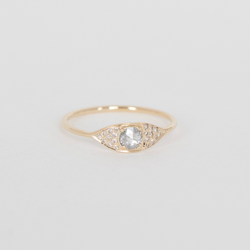 Gold ring with a diamond on a light gray background