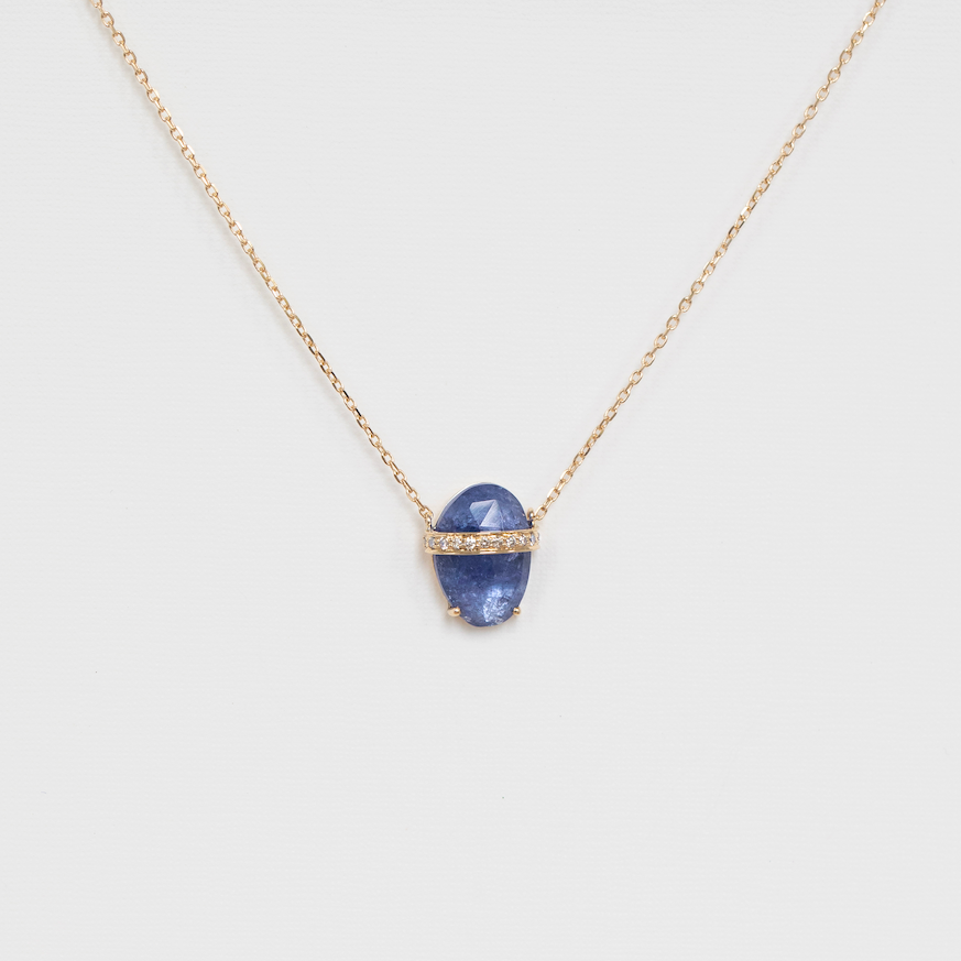 Necklace with a blue pendant on a light gray background
