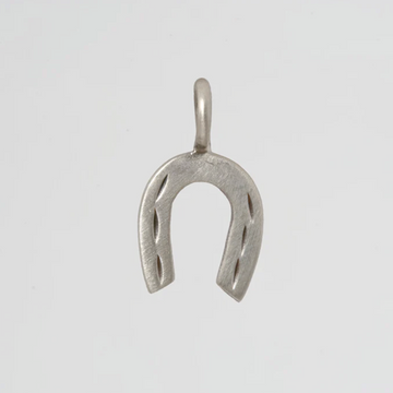 Silver horseshoe pendant on a light gray background