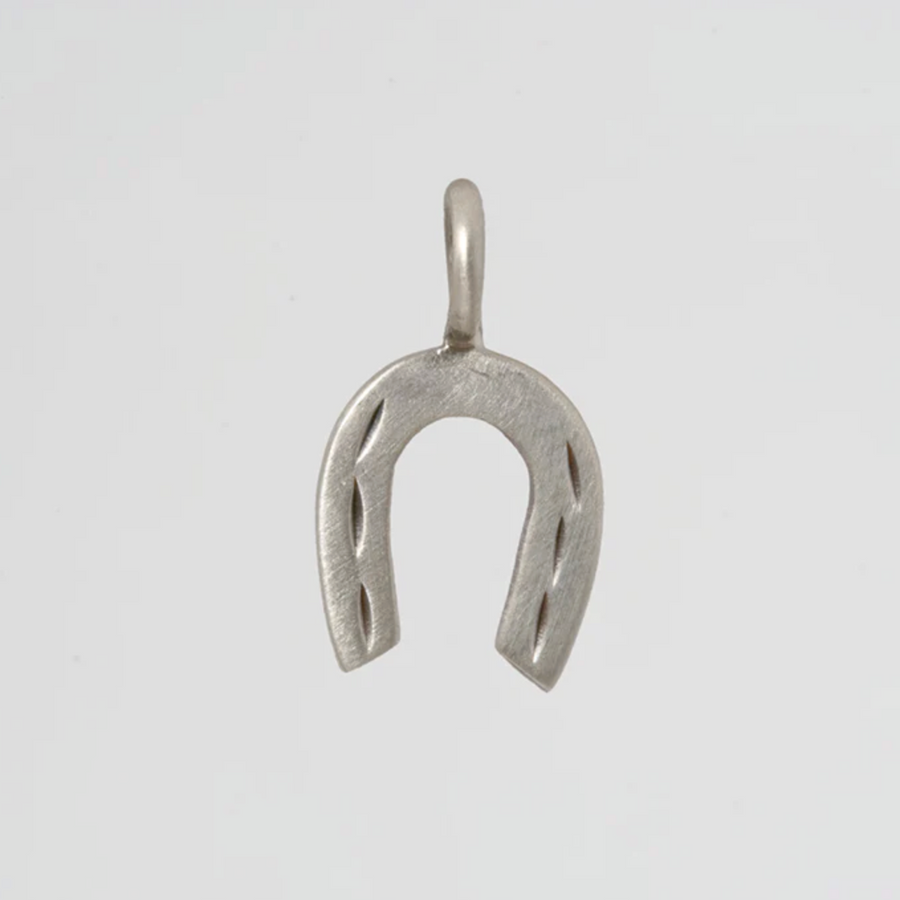 Silver horseshoe pendant on a light gray background