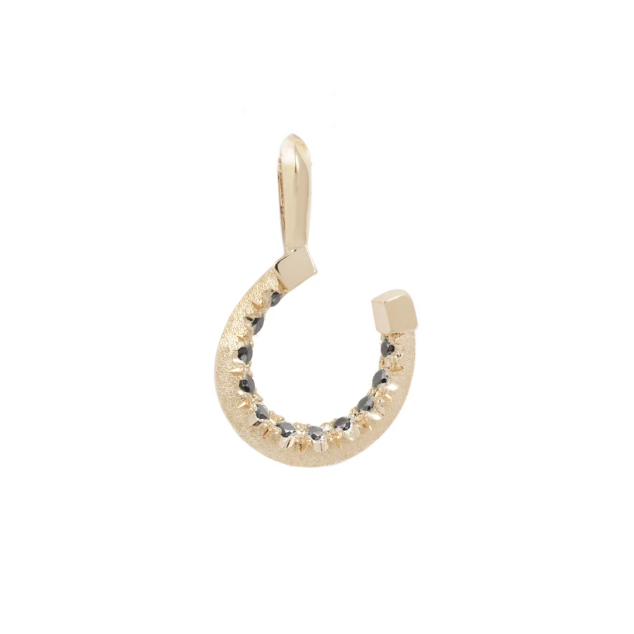 Gold horseshoe-shaped pendant with embedded black diamond stones on a white background