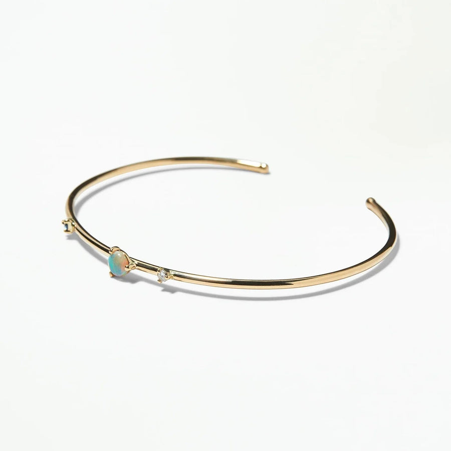 Gold bracelet with small stones on a white background