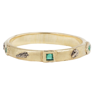 Gold band with different geometric shaped emerald and white gold accents 3/4 around the ring