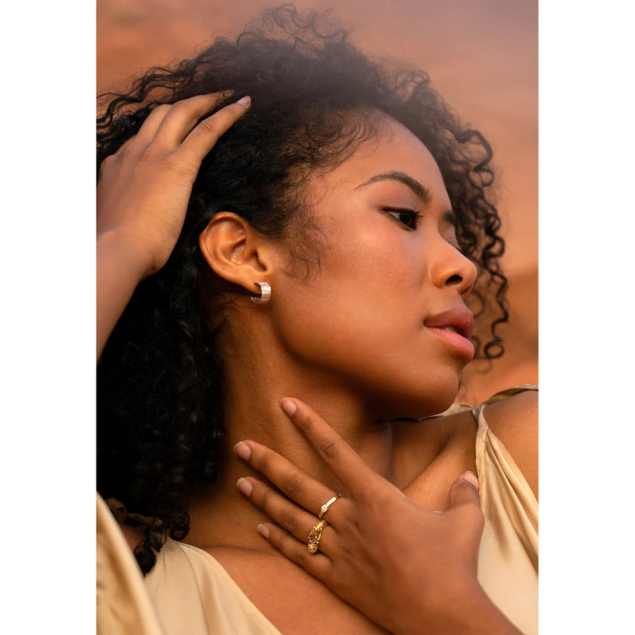 A subtle leaf texture is hand carved on the front of these silver hoops on model