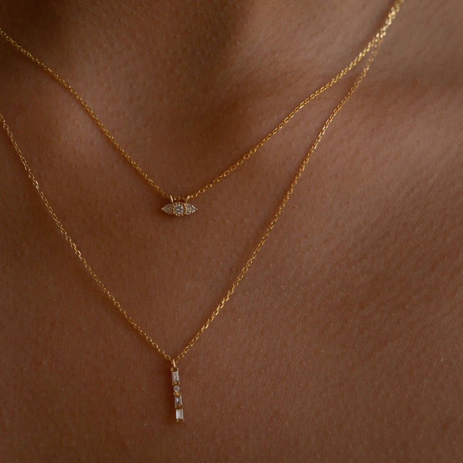 A solitary line of baguettes with a single round diamond, all hung on a delicate 16