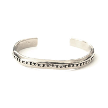 Cuff with inlaid granulation detailing. 2.5 inches in diameter.
