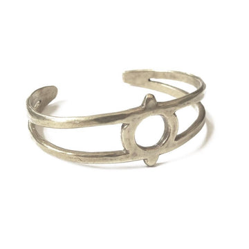 Hand carved cuff with eye symbol cutout at the center.