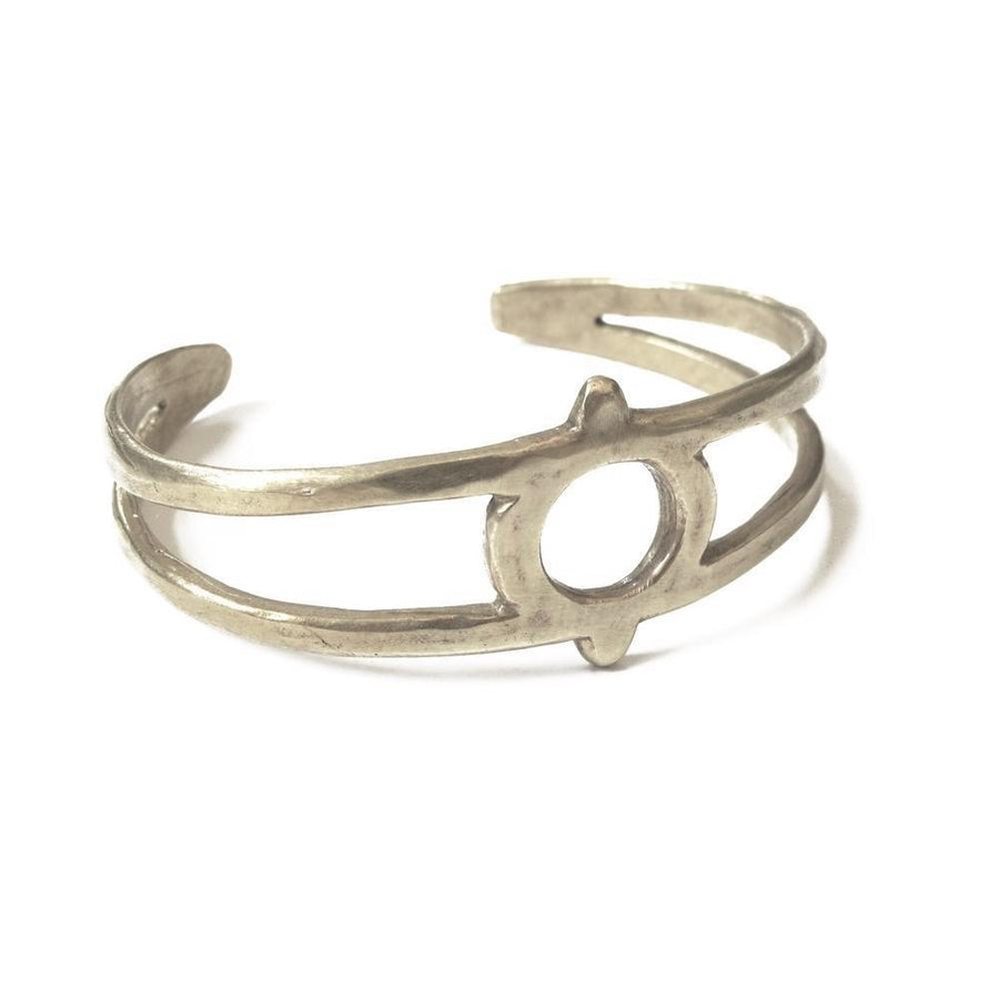 Hand carved cuff with eye symbol cutout at the center.