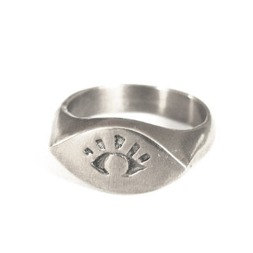 Silver ring with engraved design on a white background