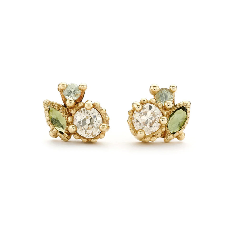 Clusters of champagne diamonds and green sapphires set amongst intricate golden granules and decorative details, on studs. 