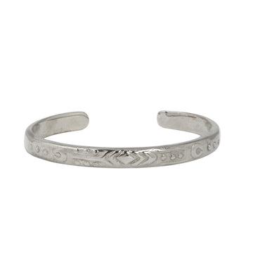 Simple cuff with intricate geometric hand carved detailing around the edge