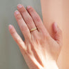 2 of 6: A oval face signet ring with a sweet little olive branch hand engraved on the front on a models hand