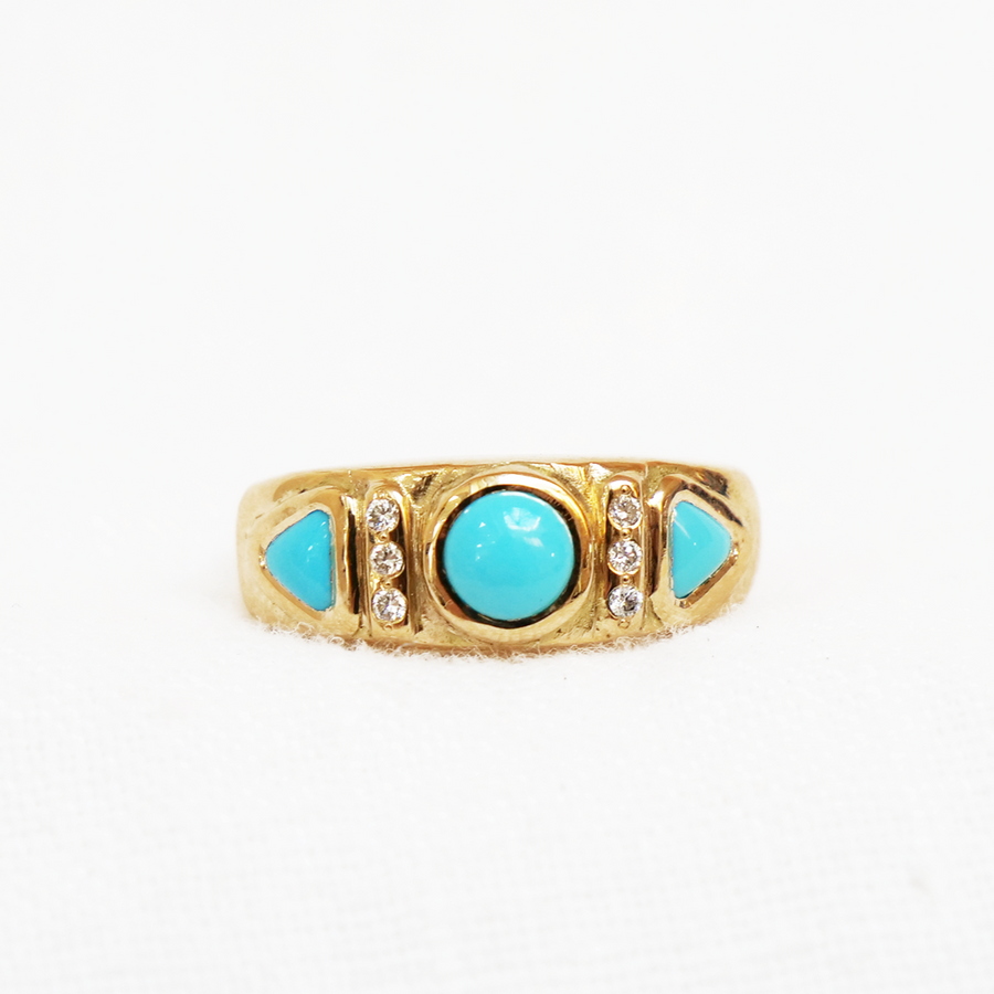 High polish 18k gold, set with a sleeping beauty turquoise round cabochon in the center, with three recycled melee diamonds in a row on either side, and two triangular turquoise cabochons after that.-Marisa Mason